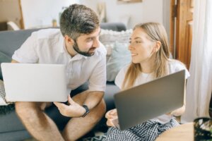 man-and-woman-holding-their-laptops