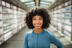 happy-black-woman-standing-on-footbridge