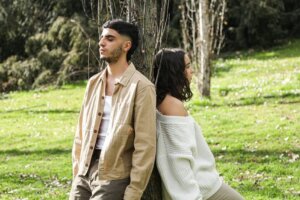 man-and-woman-leaning-on-a-tree